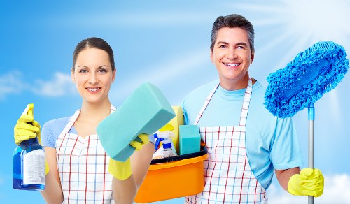 Staff member managing carpet cleaning tools with attention to manual handling